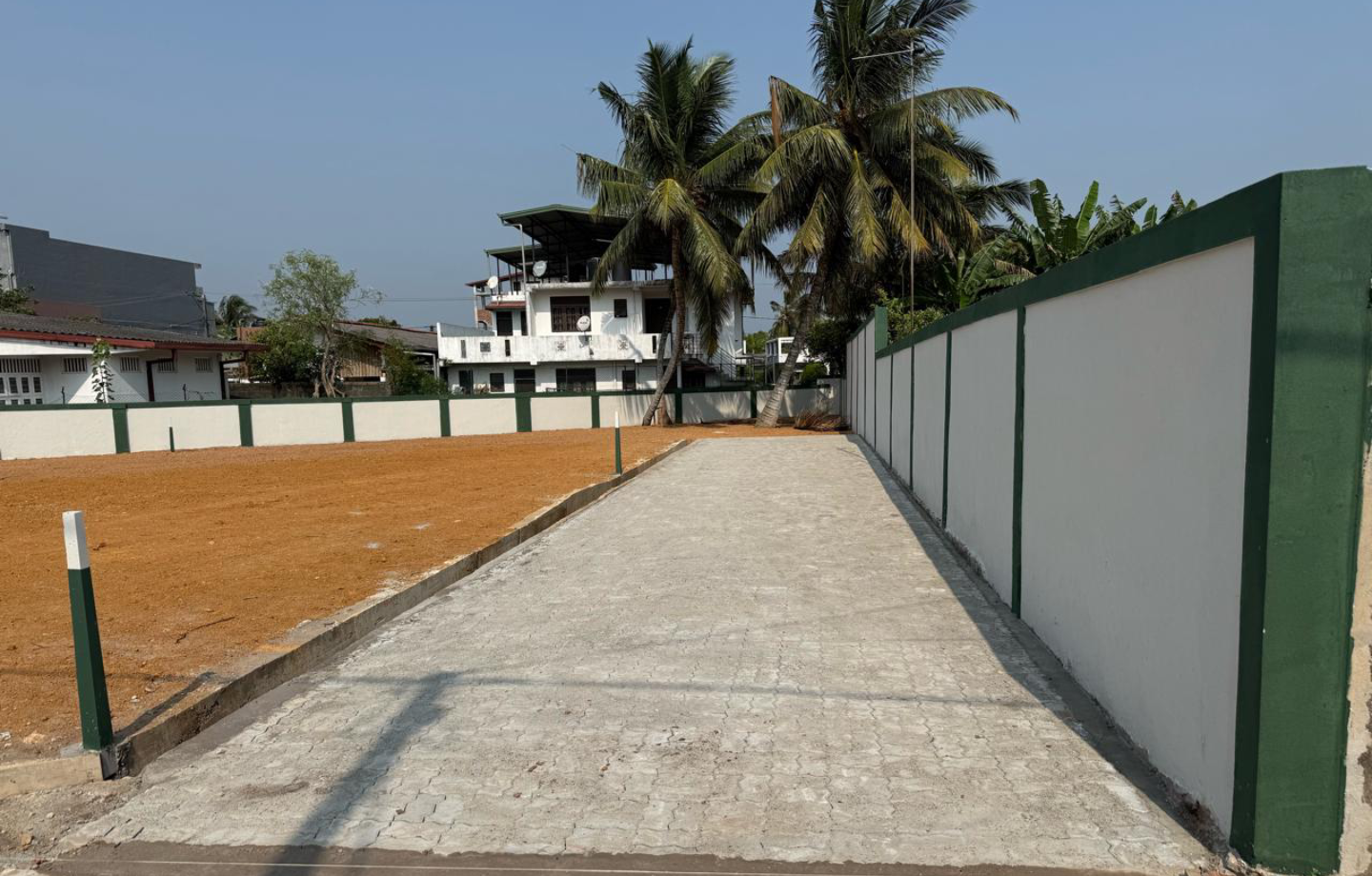 Concrete pathway between compound walls